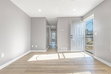 Foyer featuring light wood-type flooring and a tex