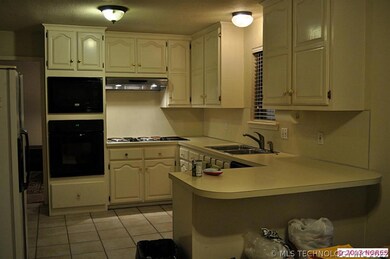 Kitchen has lots of storage, tile floor, eating no
