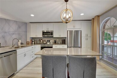 Kitchen with sink, stainless steel appliances, whi