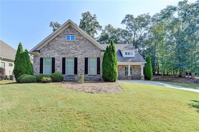 View of front of house featuring a front lawn and brick siding