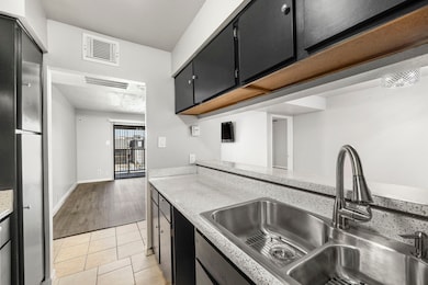 Alternate kitchen view overlooking eat-in bar, dining and living room.