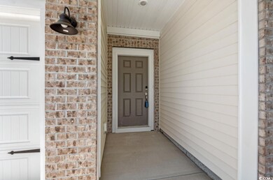 Doorway to property featuring brick siding