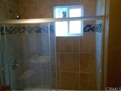 Renovated bathrooms feature tile showers with glas