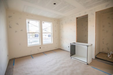 Empty room with wallpapered walls and carpet flooring