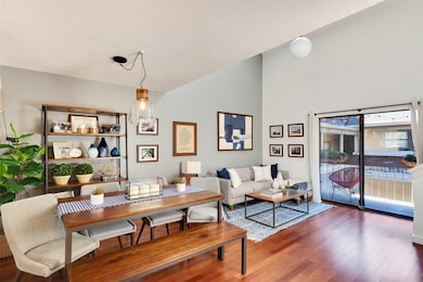 Dining area with high vaulted ceiling and wood fi