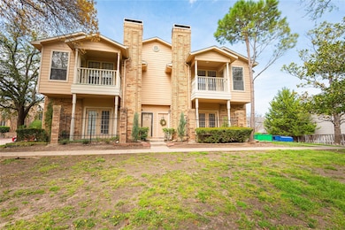 View of front of house with a balcony, a chimney, 