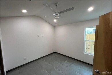 Unfurnished room featuring recessed lighting, lofted ceiling, a ceiling fan, and baseboards