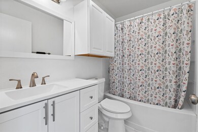 Bathroom featuring toilet, shower / bathtub combi