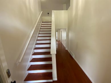 Staircase featuring wood finished floors and baseboards