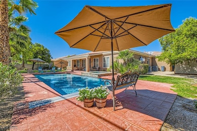 View of swimming pool with fence, an in ground hot