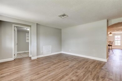 Living Room. View Into Third Bedroom On Left And View Into Kitchen/Family Room On the Left