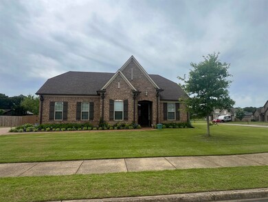 View of front of home featuring brick siding and roof with shingles