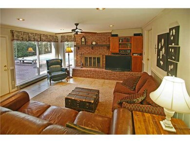 Den with fireplace and access to pool.