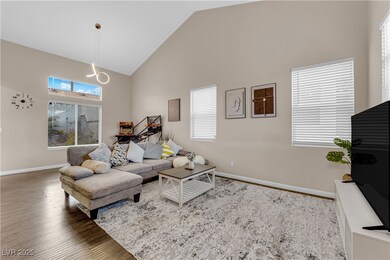 Living area featuring high vaulted ceiling, basebo