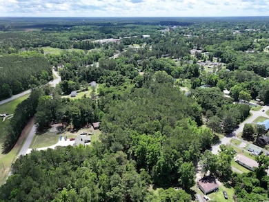 Aerial view featuring a forest view