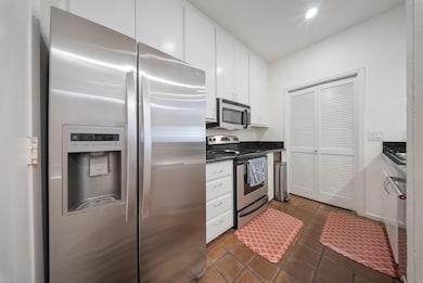 Bright galley-style kitchen with sleek granite cou