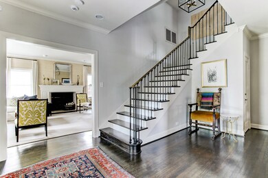 Upon entry, notice the light & bright tone found within this home as gleaming hardwoods lead one inside. The home holds a classic foyer with stunning cased openings and soaring high ceilings. Notice the exquisite Urban Electric Chisholm chandelier.