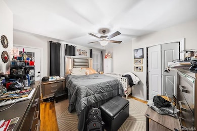 Bedroom featuring wood finished floors and ceiling fan