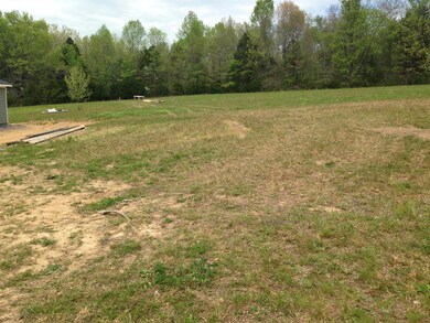 Large 1.51 acre lot. Driveway easement included in acerage. Picture is of a similar home.