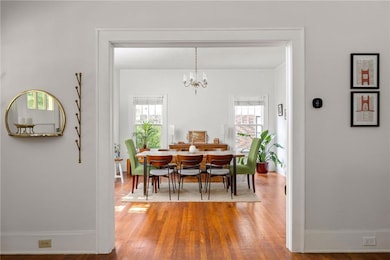 Dining room featuring wood finished floors and a chandelier