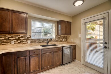 Kitchen with decorative backsplash, dishwasher, da