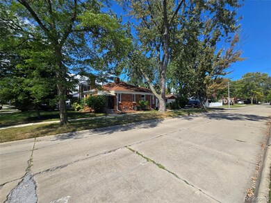 View of front of home with brick siding, a front lawn, and a chimney