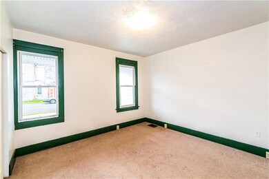INVITING LIVINGROOM ACCENTED BY FRAMED WINDOWS.