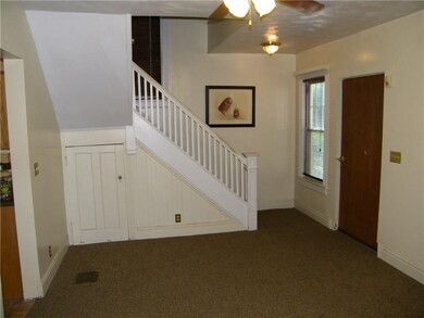 Staircase to the second floor offers storage under