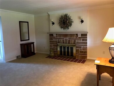 Gas log fireplace in living room.