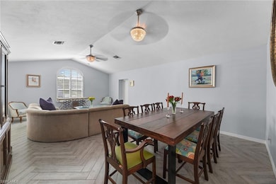 Dining area featuring parquet flooring, ceiling fa