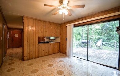Unfurnished living room with wooden walls, ceiling