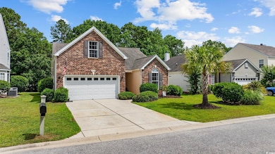 Traditional-style house featuring brick siding, central AC unit, driveway, a front yard, and a shingled roof
