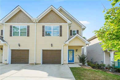 View of front of home with driveway and a garage
