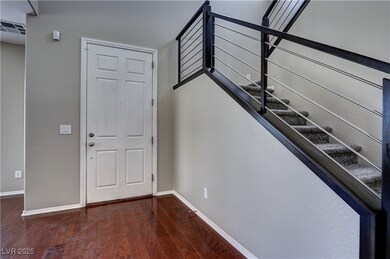 Entryway featuring wood-type flooring and baseboards