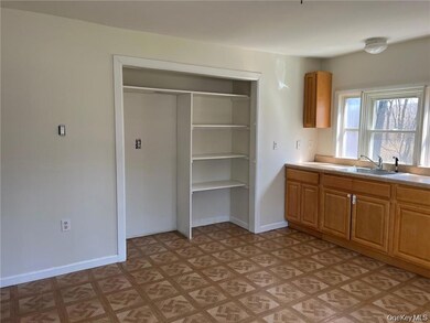 Kitchen featuring light countertops and brown cabinets