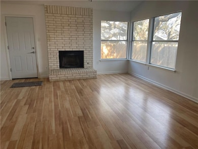 Unfurnished living room featuring wood finished f