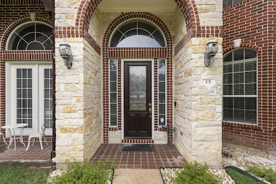 Doorway to property with brick siding and stone siding