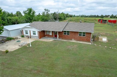 Front of home. Detached garage to left.