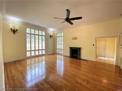 LIVING AREA WITH LARGE WINDOWS, FIREPLACE AND ENTR
