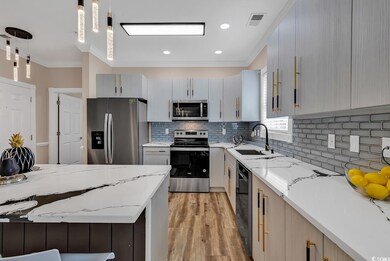 Kitchen with sink, decorative light fixtures, appl