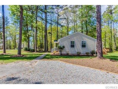 A large,  curved driveway leads you to this home's