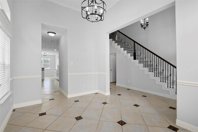 Formal dining located right off the entry, with kitchen connect, making serving your delicious meals a breeze! has matching tile floor and walls of arched windows. Notice the new light fixtures with modern black tones.