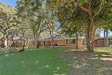 View of front of property with brick siding and a front lawn