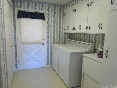 Large indoor laundry room with lots of cabinetry, 