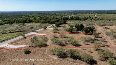 View of rural area with a forest and property bou