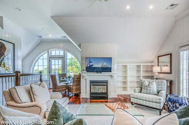 Dining/bar area opens to a private balcony overlooking the green yard and pool area
