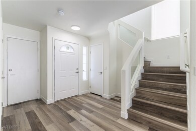 Foyer featuring stairway, wood finished floors, an
