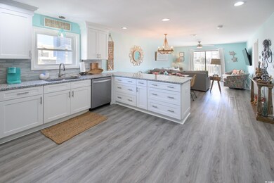 Kitchen featuring sink, white cabinets, stainless 