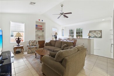 Living room with light tile patterned floors, ceil