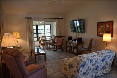 Living room with ceramic tile plank flooring and s